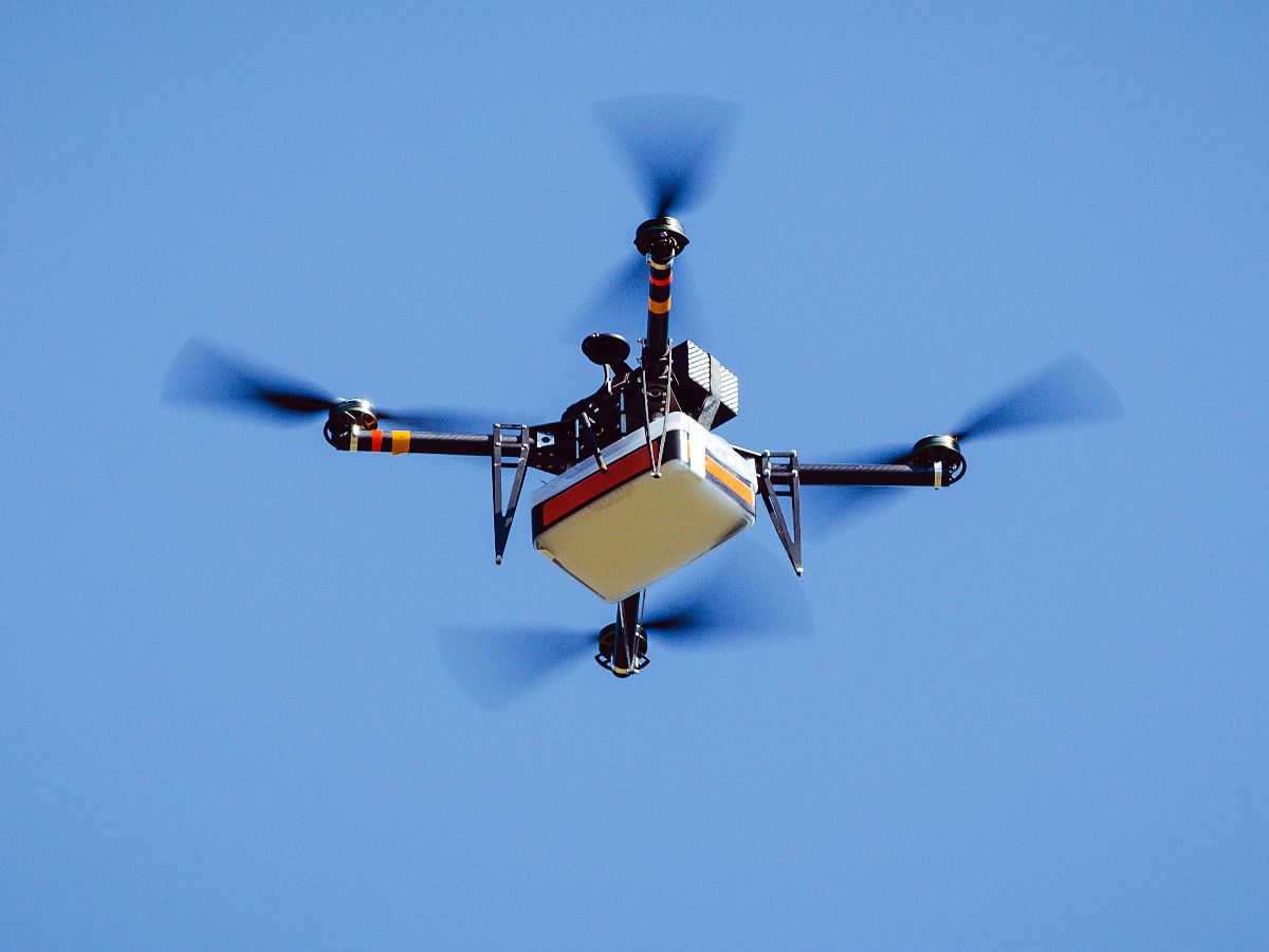 Autonomous UAV delivery cargo drone flying during an edge AI-powered logistics mission